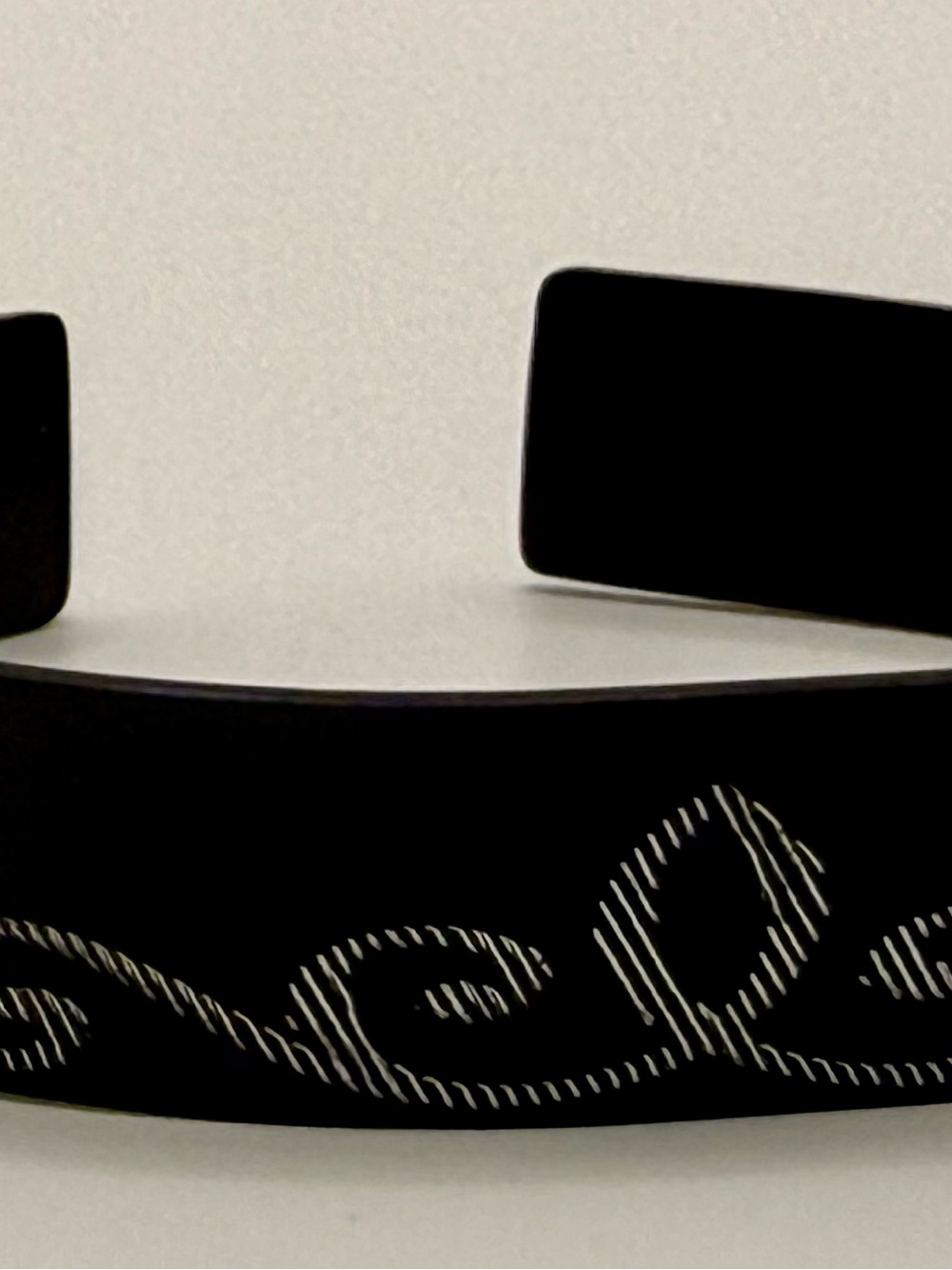 Black metal cuff bracelet with engraved Detail